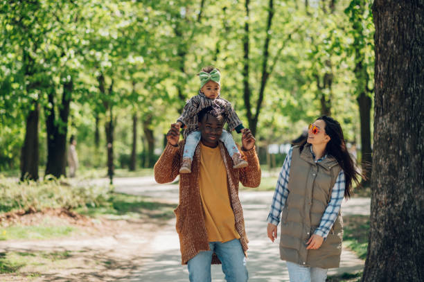istock Multiracial family having fun in the park 1396120487