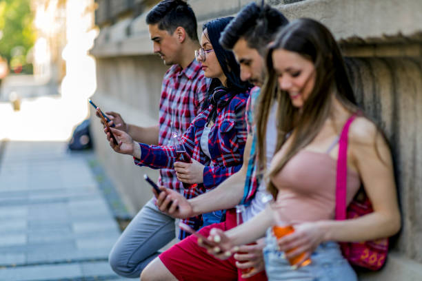 istock Group of friends watching smart mobile phones 1396120547