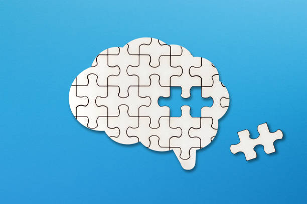 istock Brain shaped white jigsaw puzzle on blue background, a missing piece of the brain puzzle, mental health and problems with memory 1396122558