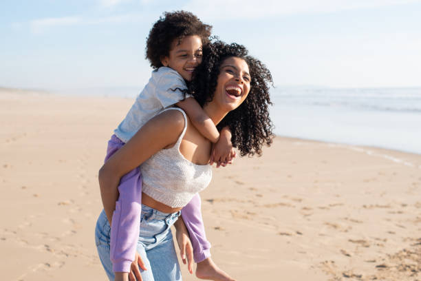 istock Contented mother and daughter spending time on beach 1396123229