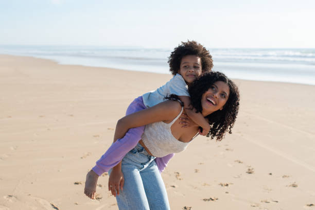 istock Pleased mother and daughter spending time on beach 1396123274