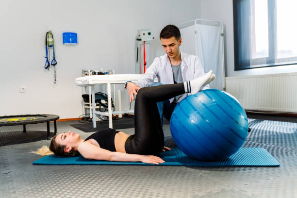 istock Female patient working with physical therapists pilates exercise 1396128451