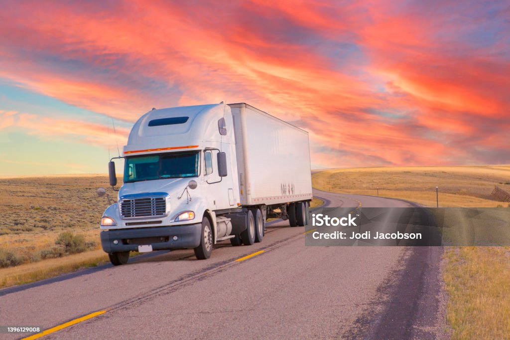 Long haul trucking Long haul trucking on a rural highway at dusk. Truck Stock Photo