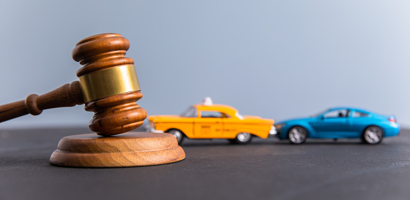Judge gavel and two cars colliding, traffic accident