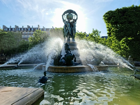 The Fontaine de l'Observatoire is a monumental fountain located in the Jardin Marco Polo, south of the Jardin du Luxembourg in the 6th arrondissement of Paris. The image shows the fountain which was realized in the time 1867-1874 during springtime.
