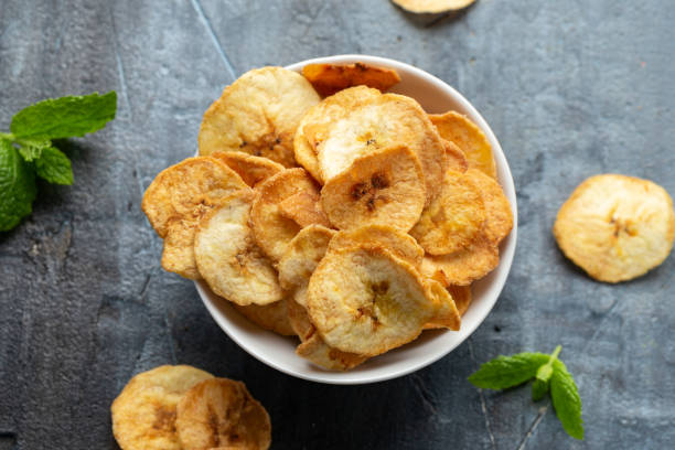 istock Dried banana chips, snack in white bowl 1396133673