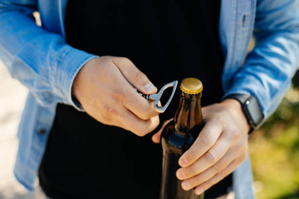 istock man opening a bottle of beer with opener 1396133674