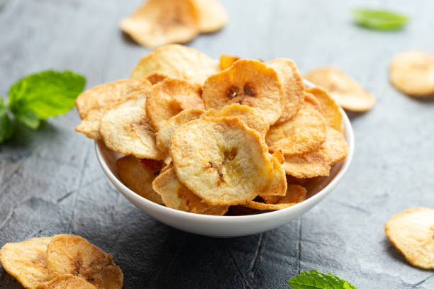 istock Dried banana chips, snack in white bowl 1396133675