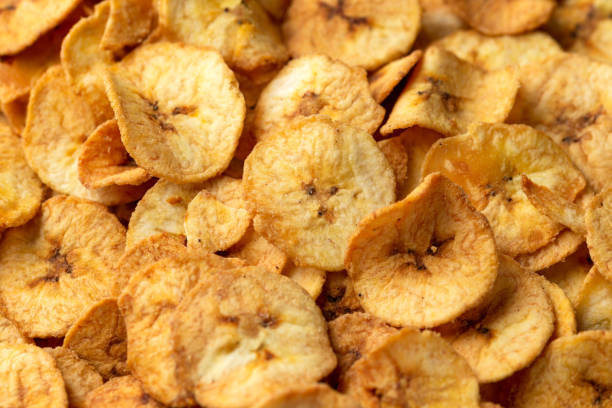 istock Sweet dried banana chips, snack background, texture 1396133713