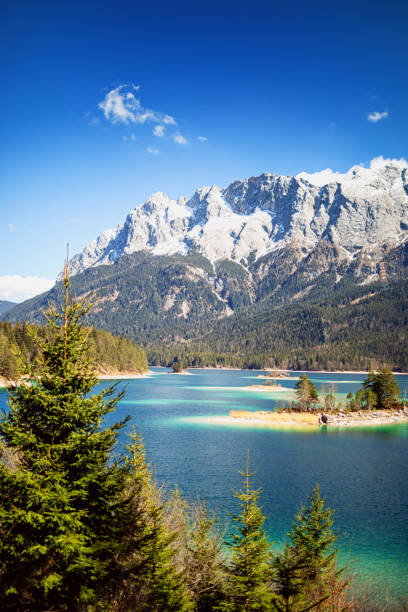 Wonderful view of the crystal clear Eibsee with the Bavarian Alps and the Zugspitze in the background Wonderful view of the crystal clear Eibsee with the Bavarian Alps and the Zugspitze in the background. zugspitze mountain stock pictures, royalty-free photos & images