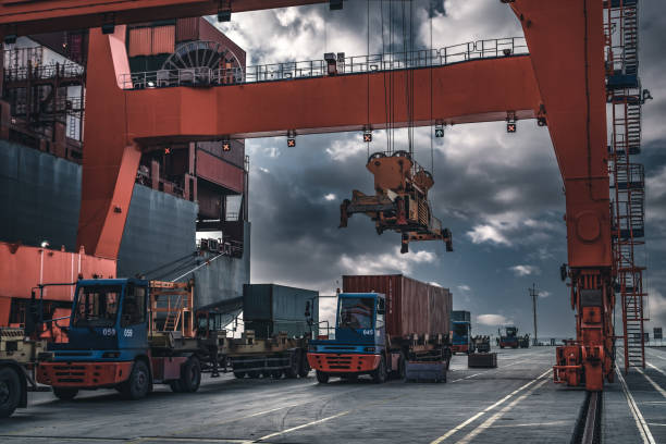 istock Crane lifting up container in a port. 1396136147