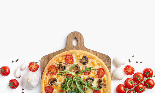 Pizza margherita with mushrooms and basil on a wooden board and white background. Culinary background