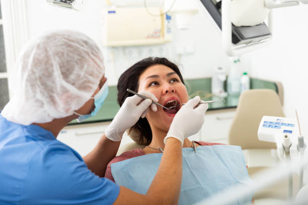 istock Dentist examining asian female patient teeth 1396139789