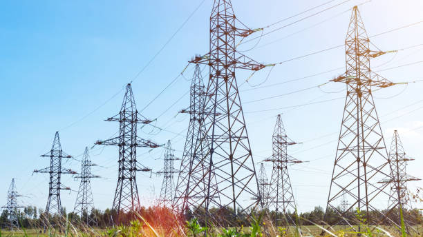 istock Transmission pylons with high-voltage power lines with copy space. Transmission towers in industrial landscape. High voltage electric transmission towers. Electricity transmission through power lines. 1396140632