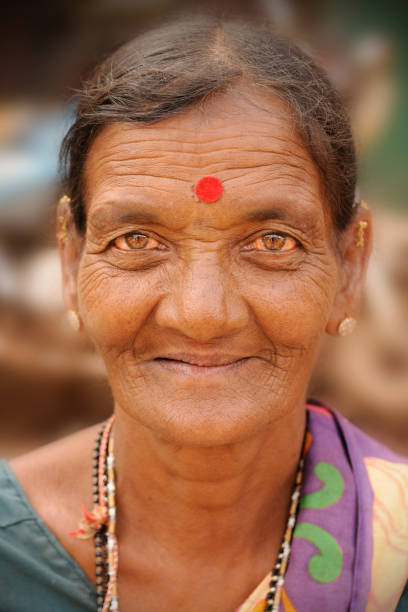 Close up portrait of smiling elderly Indian lady at Mapusa Friday Market. The regional weekly market in Mapusa, North Goa is a major tourist attraction.