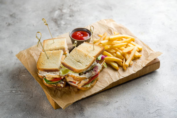 club sandwich with chicken and french fries with ketchup on grey table - club sandwich sandwich french fries turkey imagens e fotografias de stock