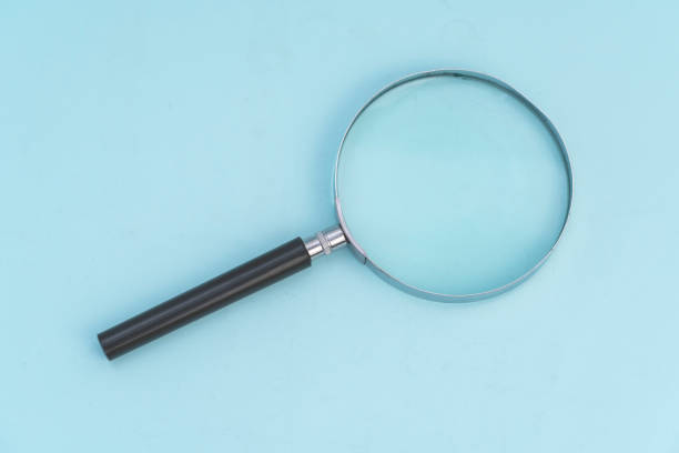 Vintage magnifying glass on wooden table.