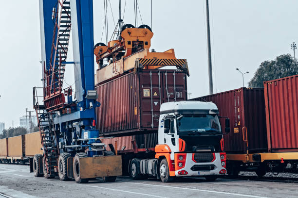 istock Crane lifting up container in a port. 1396146591