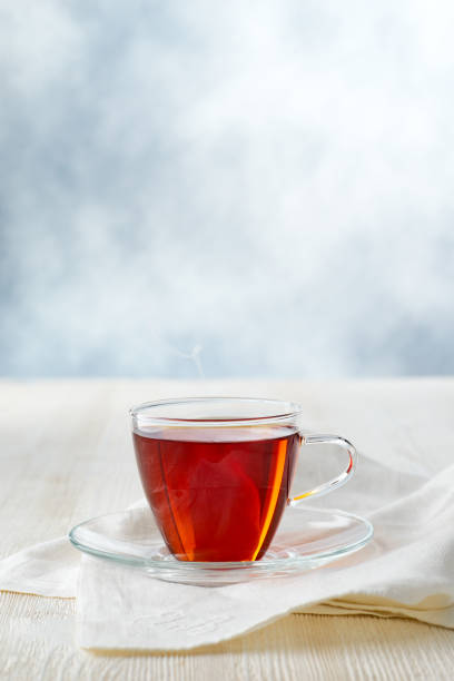 istock Glass cup of black tea on white wooden table 1396146642