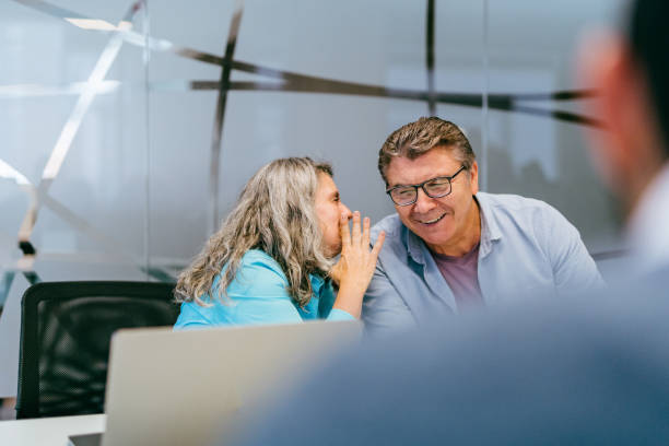 istock Business colleagues whispering at meeting 1396146727