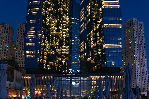 Dubai, UAE - 07 10 2020: Night view to the Rixos Premium Dubai JBR,  showing amazing modern skyscraper building illuminated with lights. Luxury hotel resort located at the beachfront.