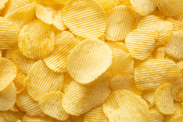 istock crispy golden potato chips snack texture background 1396160628