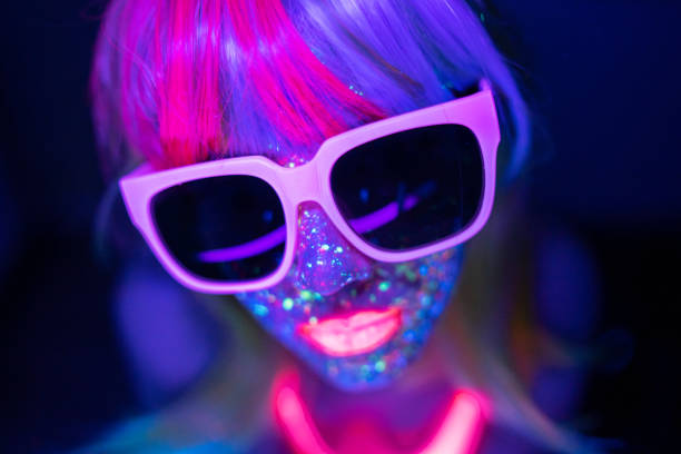 Portrait of a young girl under UV lights A neon light portrait of a young girl wearing eyeglasses dance & electronic music stock pictures, royalty-free photos & images