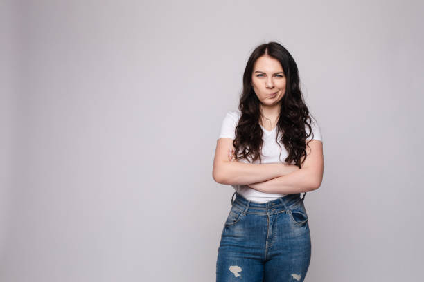 istock Angry or sad girl with folded arms. 1396161027