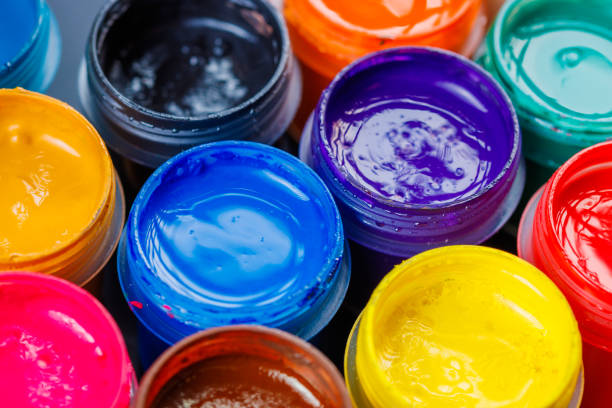 istock full-frame close-up background of opened small gouache paint jars 1396161359
