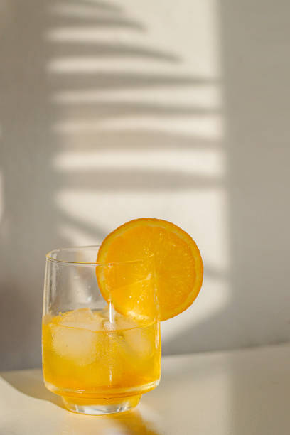 istock Alcohol cocktail with ice cubes on white background with hard light and shadow. Summer time and vacation concept. 1396161372