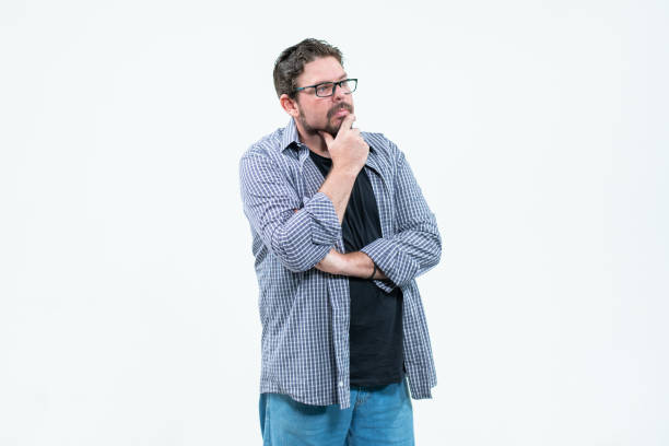 Southeast Asian man wearing flannel shirt  thinking about something while looking to upper right corner, on white isolated background