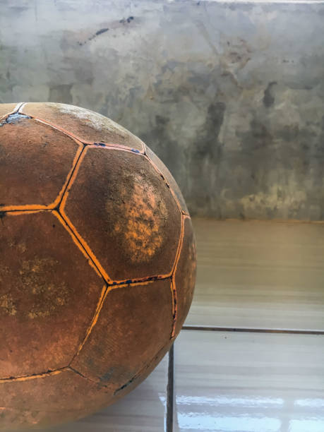 istock Old orange soccer ball 1396171188