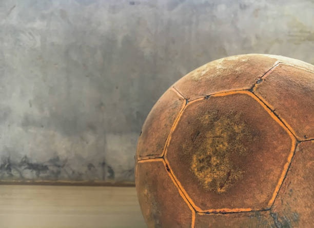 istock Old orange soccer ball 1396171229