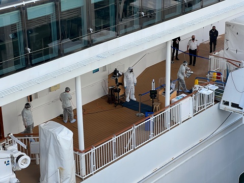 Vancouver, British Columbia, Canada - April 25, 2022:  Coronavirus precautions on a cruise ship. Seamen with hazmat suits.