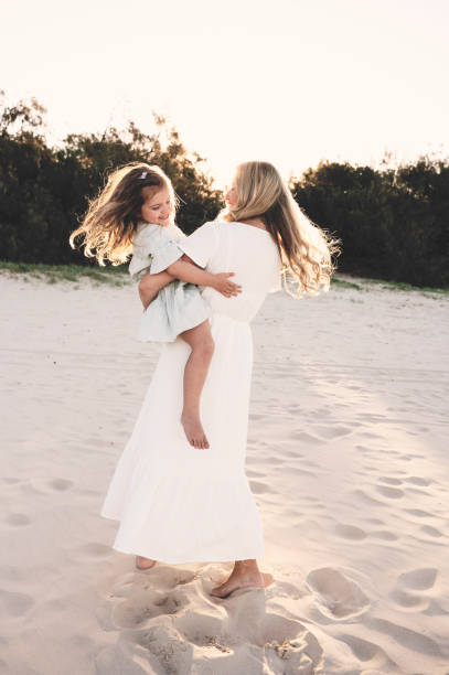 istock Mother holding daughter and spinning 1396178082