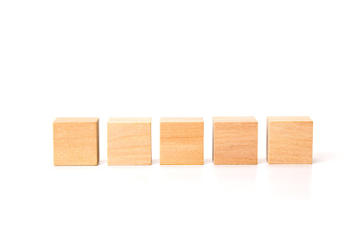 Five Blank game board wooden tiles on white background.