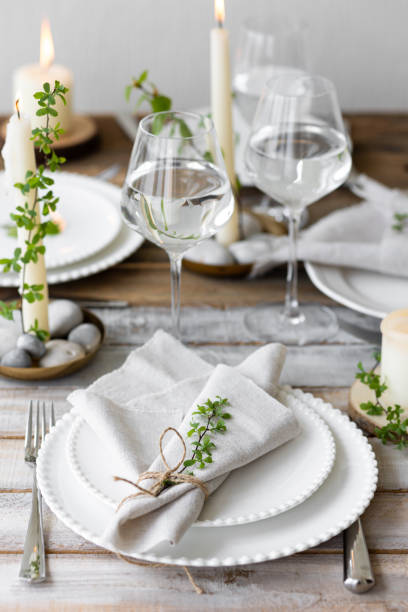istock Rustic zero waste wedding decor with natural elements. Wooden table, candles, linen napkins, branches with green leaves. Eco-friendly decoration for the special dinner. Romantic and cozy place 1396186262