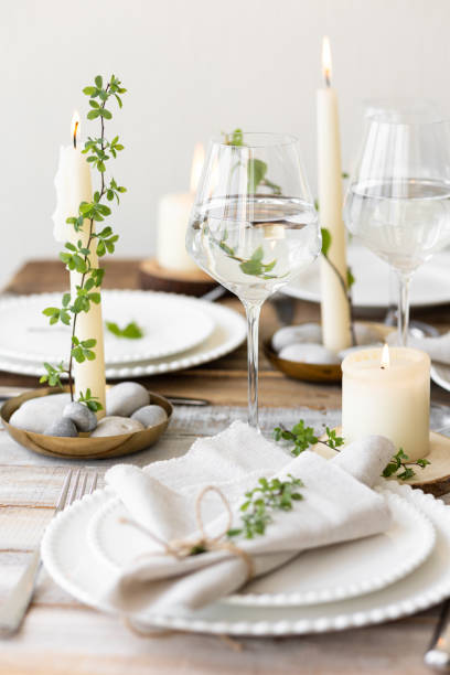 istock Rustic zero waste wedding decor with natural elements. Wooden table, candles, linen napkins, branches with green leaves. Eco-friendly decoration for the special dinner. Romantic and cozy place 1396186268