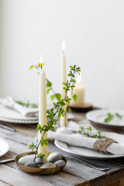 istock Rustic zero waste wedding decor with natural elements. Wooden table, candles, linen napkins, branches with green leaves. Eco-friendly decoration for the special dinner. Romantic and cozy place 1396186352
