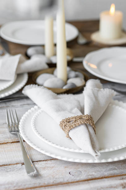 istock Rustic zero waste wedding decor with natural elements. Wooden table, candles, linen napkins, branches with green leaves. Eco-friendly decoration for the special dinner. Romantic and cozy place 1396186374