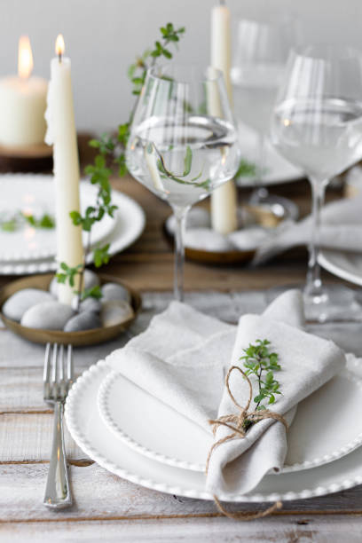 istock Rustic zero waste wedding decor with natural elements. Wooden table, candles, linen napkins, branches with green leaves. Eco-friendly decoration for the special dinner. Romantic and cozy place 1396186420