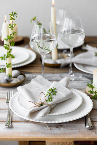istock Rustic zero waste wedding decor with natural elements. Wooden table, candles, linen napkins, branches with green leaves. Eco-friendly decoration for the special dinner. Romantic and cozy place 1396186434