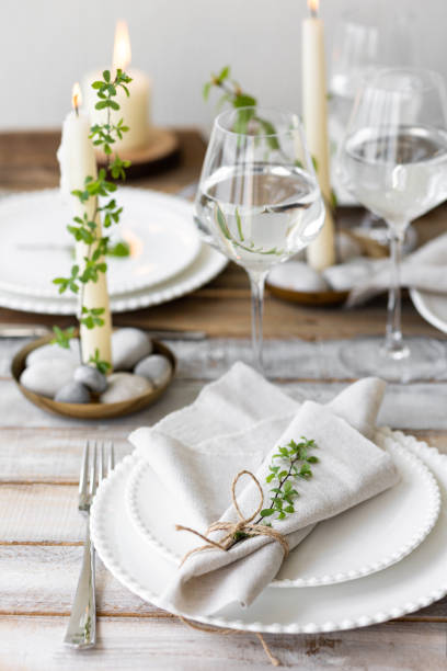 istock Rustic zero waste wedding decor with natural elements. Wooden table, candles, linen napkins, branches with green leaves. Eco-friendly decoration for the special dinner. Romantic and cozy place 1396186436