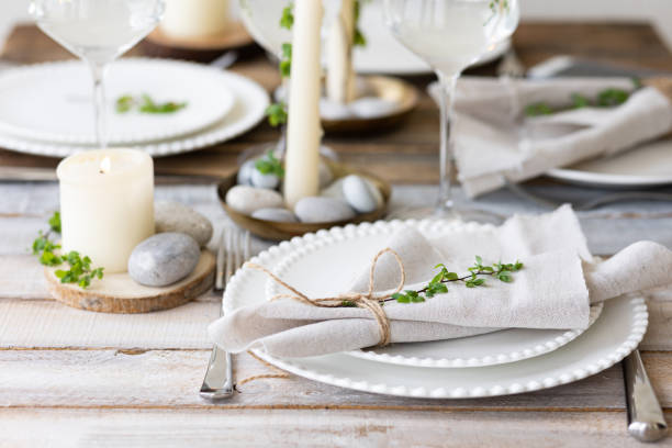 istock Rustic zero waste wedding decor with natural elements. Wooden table, candles, linen napkins, branches with green leaves. Eco-friendly decoration for the special dinner. Romantic and cozy place 1396186490