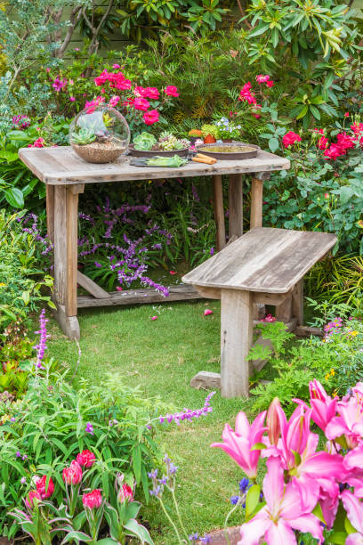 istock Gardening tools on table and spring flower on the terrace in garden 1396188681