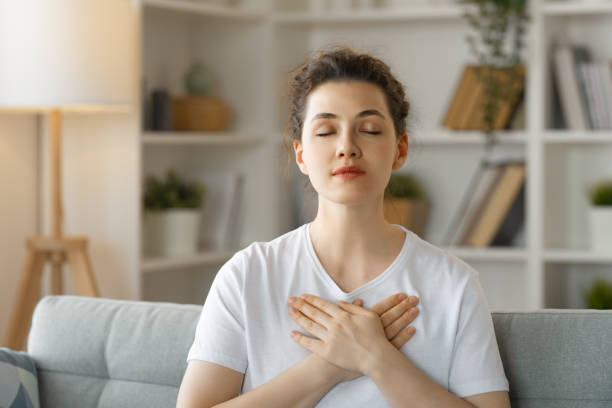 istock woman holding hands on her chest 1396191669