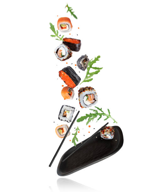 istock Various fresh sushi are falling on a black clay plate 1396194888