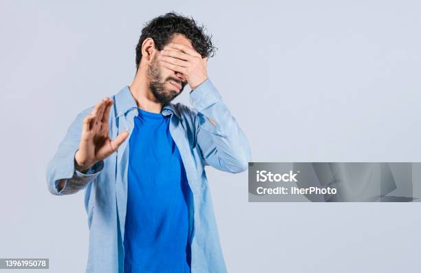 Scared Confused Man Closing Eyes With Palm Of Hand Stock Photo - Download Image Now - Hiding, Men, Pursuit - Concept