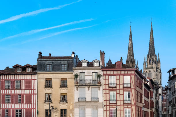 Bayonne in the pays Basque, typical facades, with the cathedral in background Bayonne in the pays Basque, typical facades with colorful shutters in the historic center, with the cathedral Sainte-Marie in background sainte marie stock pictures, royalty-free photos & images