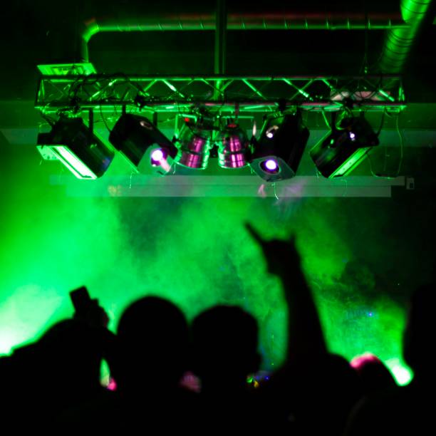istock raised hands of crazy people at a rock concert, front and back background is blurred with bokeh effect 1396196143